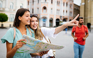 a happy couple use a map to navigate an unfamiliar city together